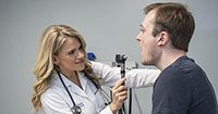 Doctor looking into a patient's mouth