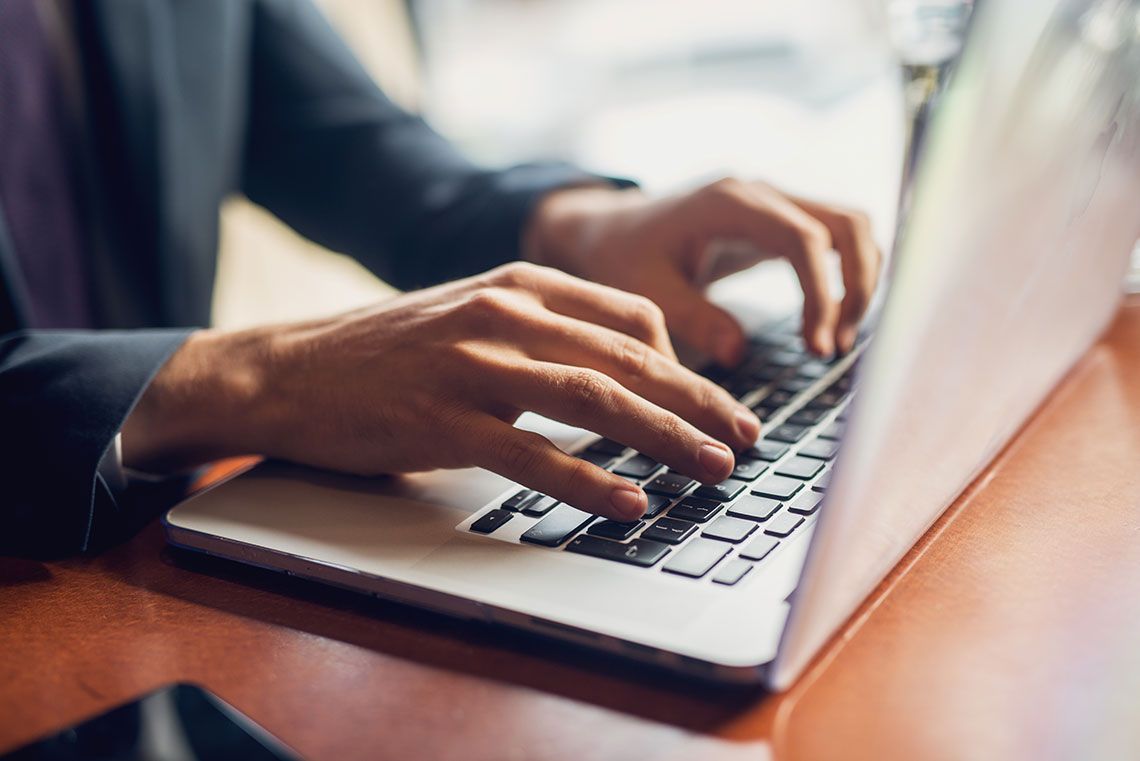 Student typing on a laptop